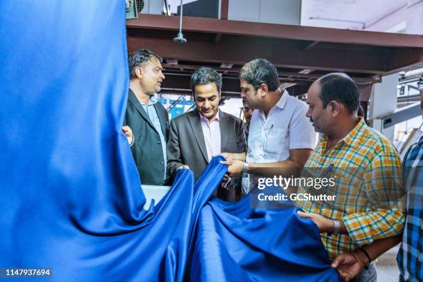 textile industry owner inspecting the quality - textile industry stock pictures, royalty-free photos & images