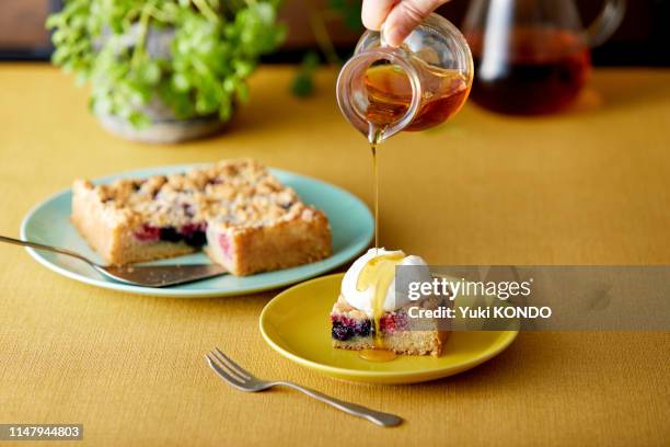 drop maple on crumble cake with fresh cream. - maple syrup stock pictures, royalty-free photos & images