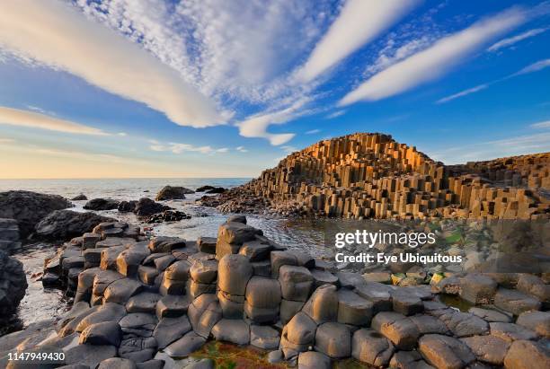 Ireland. County Antrim. Giants Causeway. Dramatic cloud pattern over the rocks at sunset.