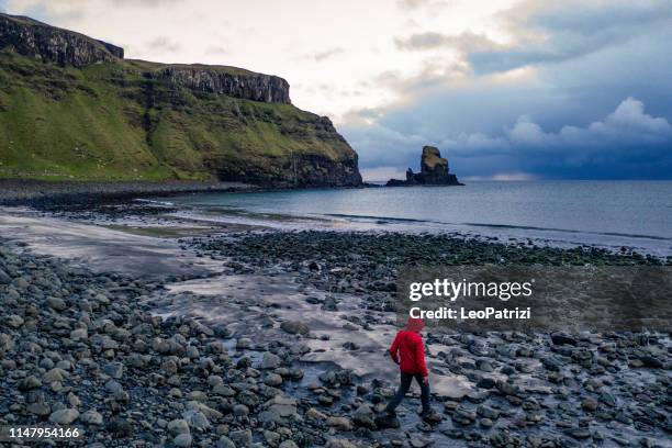 man in talisker bay beach - isle of skye stock pictures, royalty-free photos & images