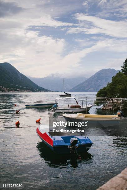 four fishing boats and yacht in the bay of kotor in summer - kotor stock-fotos und bilder