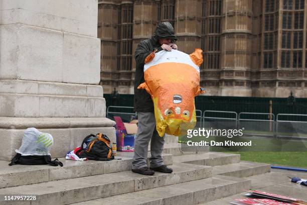 Protester inflates a Donald Trump baby balloon as US President Donald Trump and First Lady Melania Trump visited 10 Downing street for a meeting on...