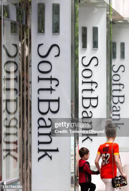 Pedestrians walk past a SoftBank Corp. Store on May 9, 2019 in Tokyo, Japan. SoftBank Group Corp. Announced its financial results for the fiscal year...