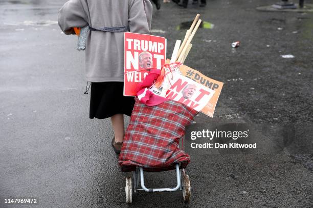 Protester gathers up anti Donald Trump signs as US President Donald Trump and First Lady Melania Trump visited 10 Downing street for a meeting on the...