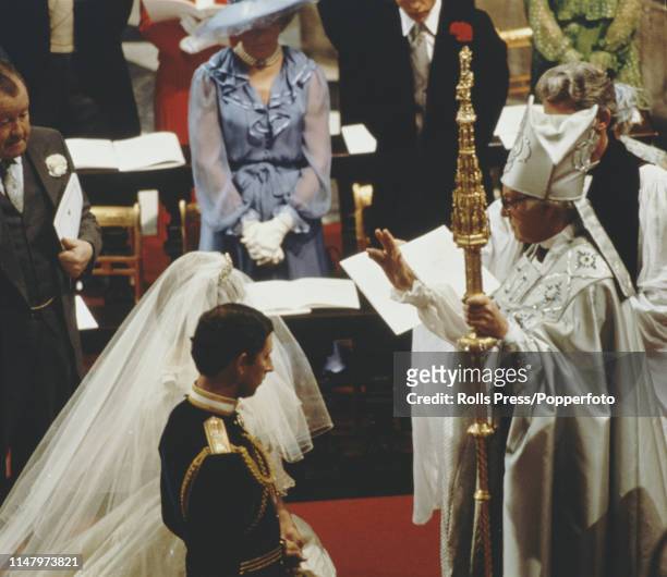 Prince Charles and Diana Spencer are blessed by Archbishop of Canterbury Robert Runcie , as father of the bride John Spencer, 8th Earl Spencer look...