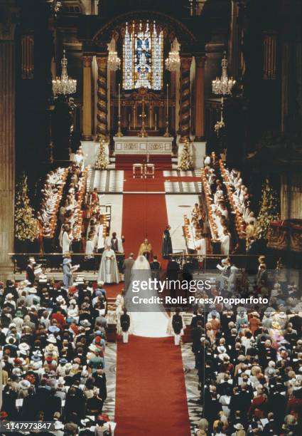 Prince Charles and Diana Spencer are blessed by Archbishop of Canterbury Robert Runcie during their royal wedding ceremony under the dome inside St...