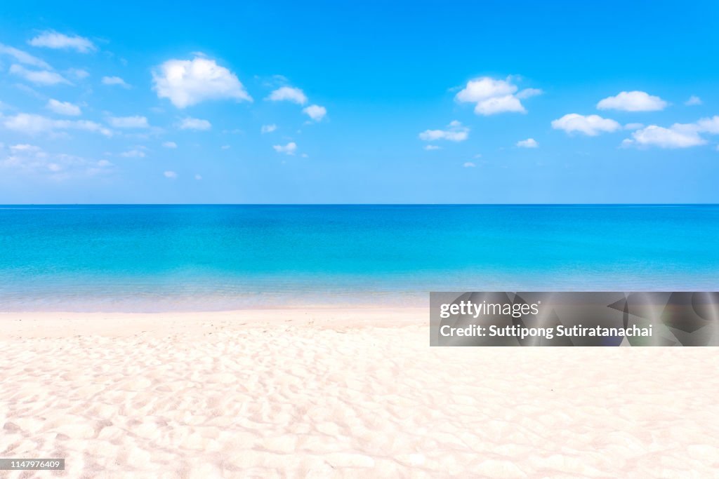 Summer beach background. Sand and sea and blue sky