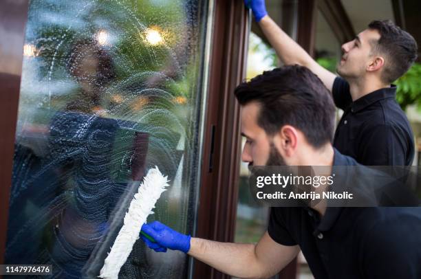 window cleaner on his job - washing windows stock pictures, royalty-free photos & images