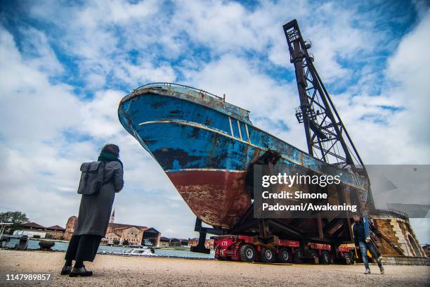 The wreck of the Barca Nostra which sank in 2015 with several hundred migrants on board is on display during the press previews of the 58th...