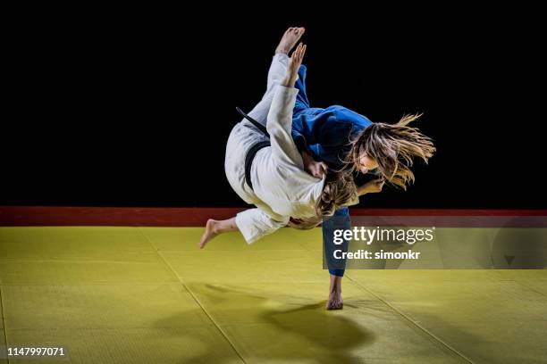 judo players competing in judo match - judo female stock pictures, royalty-free photos & images