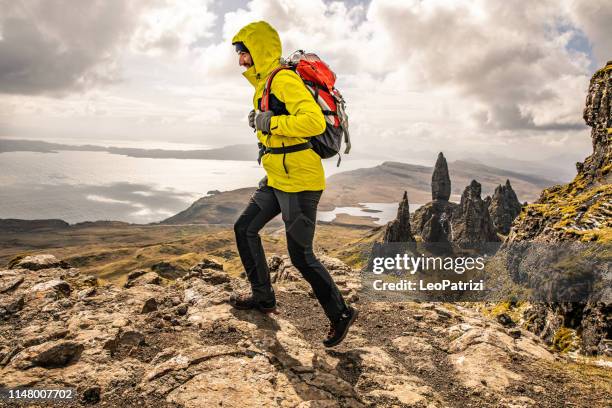 solo traveler at old man of storr in scotland, isle of skye - old man of storr stock pictures, royalty-free photos & images