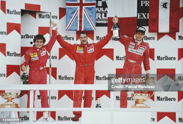 Nigel Mansell of Great Britain, driver of the Scuderia Ferrari SpA Ferrari F1-90-2 Ferrari V12 celebrates with second placed team mate Alain Prost...