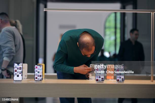 Apple retail employees keep hardware clean during a preview of the new Apple Carnegie Library two days before the grand opening May 09, 2019 in...