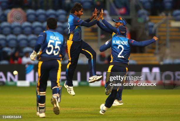 Sri Lanka's Nuwan Pradeep celebrates with team mates after taking the wicket of Afghanistan's Rashid Khan for two runs during the 2019 Cricket World...