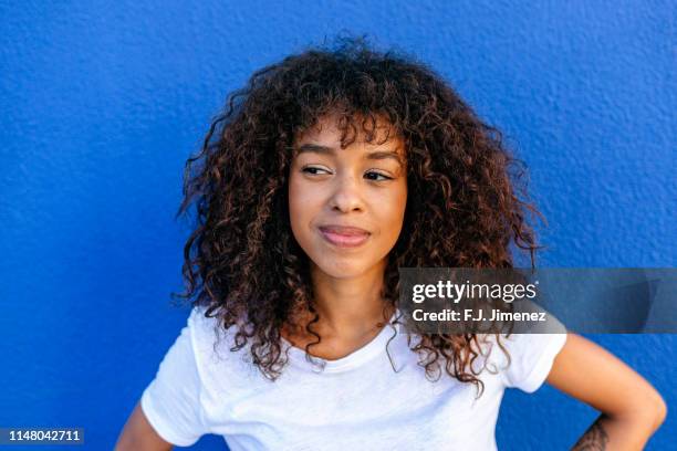 portrait of smiling woman with blue background - black woman happy white background stock pictures, royalty-free photos & images