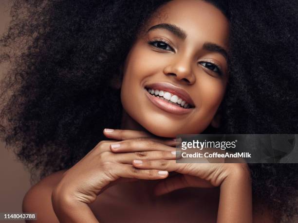 beautiful smiling girl with curly hairstyle - beautiful woman stock pictures, royalty-free photos & images