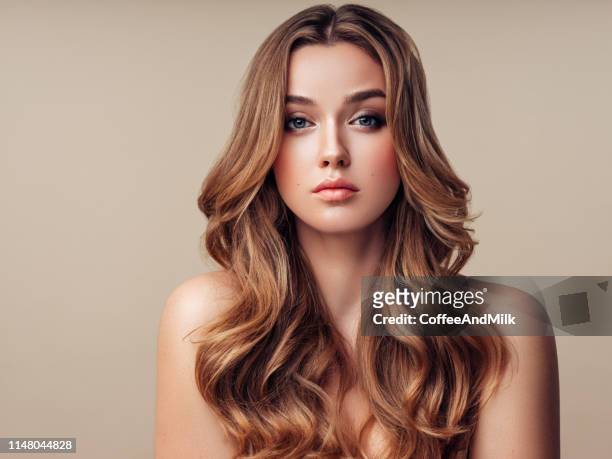 young beautiful woman with long hair - wavy hair stock pictures, royalty-free photos & images