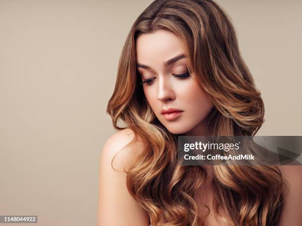 young beautiful woman with long hair - thick shiny hair stock pictures, royalty-free photos & images