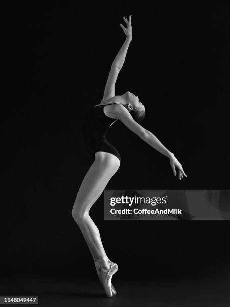 young beautiful dancer dancing on gray background - ballet dancers russia stock pictures, royalty-free photos & images