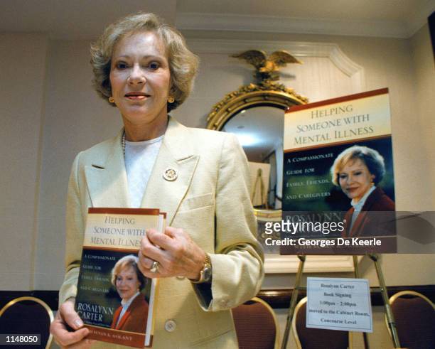 Former first lady Rosalynn Carter holds a copy of her latest book dealing with mental illness "Helping Someone with Mental Illness" July 17, 1998 in...