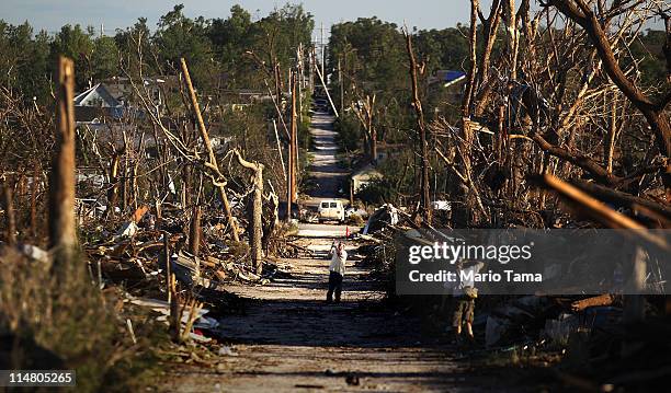 People take photos after a massive tornado passed through the town killing at least 126 people on May 26, 2011 in Joplin, Missouri. The town...