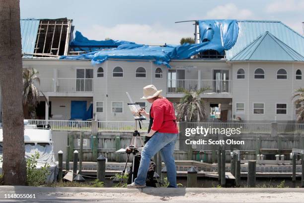 Brienne Brown, who traveled from Pennsylvania for a retreat with a group of artists, paints devastation left behind by Hurricane Michael on May 09,...