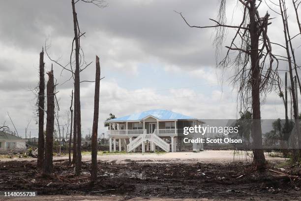 Tarp covers the roof of a home that was damaged by Hurricane Michael on May 09, 2019 in Mexico Beach, Florida. Seven months after the category five...