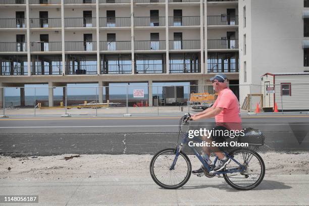 Cyclist rides by the El Governor Motel, that is being rebuilt after is was nearly destroyed by Hurricane Michael on May 09, 2019 in Mexico Beach,...