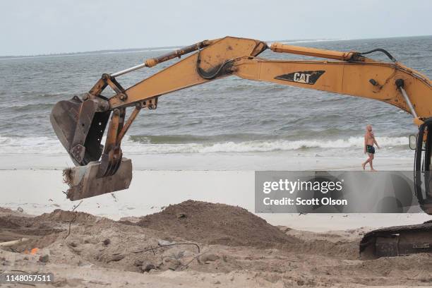 Concrete from broken building foundations destroyed by Hurricane Michael is cleared from along the beach on May 09, 2019 in Mexico Beach, Florida....