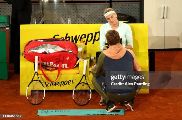 Petra Kvitova of the Czech Republic speaks with her coach Jiri Vanek in her match against Kiki Bertens of the Netherlands during day six of the Mutua...