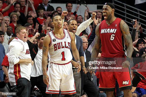Derrick Rose of the Chicago Bulls looks on dejected as LeBron James of the Miami Heat celebrates after the Heat won 83-80 in Game Five of the Eastern...