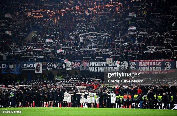 Eintracht Frankfurt players and staff stand in front of Eintracht Frankfurt fans as they show their support after the UEFA Europa League Semi Final...