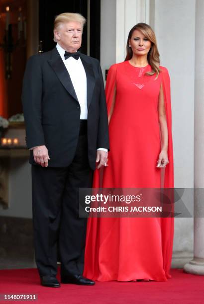President Donald Trump and US First Lady Melania Trump wait to greet Britain's Prince Charles, Prince of Wales and his wife Britain's Camilla,...