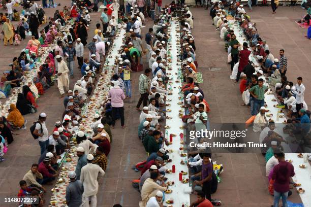 People wait to break their fast on the eve of Eid-ul-Fitr, at Jama Masjid on June 4, 2019 in New Delhi, India. With the sighting of the crescent moon...