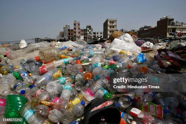 Plastic bottles and containers are seen at a garbage dump on the banks of Yamuna, near Okhla on June 4, 2019 in New Delhi, India. World Environment...