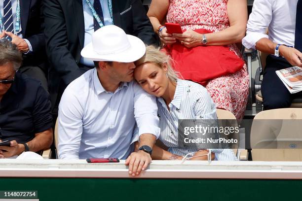 Elodie Gossuin, Bertrand Lacherie watch a game betwen Switzerlands' Roger Federer and Switzerland's Stanislas Wawrinka during their men's singles...