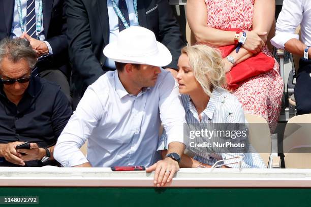 Elodie Gossuin, Bertrand Lacherie watch a game betwen Switzerlands' Roger Federer and Switzerland's Stanislas Wawrinka during their men's singles...