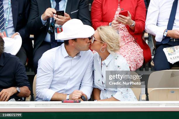 Elodie Gossuin, Bertrand Lacherie watch a game betwen Switzerlands' Roger Federer and Switzerland's Stanislas Wawrinka during their men's singles...