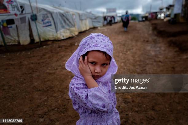 Displaced Marawi residents gather to celebrate Eidl Fitr in a makeshift prayer tent inside a shelter compound for evacuees on June 5, 2019 in Marawi,...