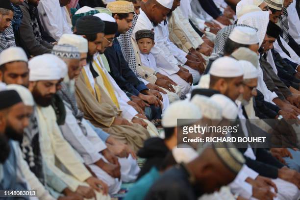 Muslim worshippers offer prayers during Eid al-Fitr at the Velodrome du Champ Fleuri stadium in Saint Denis de la Reunion, on the French Indian Ocean...