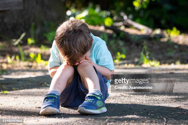 crying toddler sitting on the floor covering his face - tantrum stock pictures, royalty-free photos & images