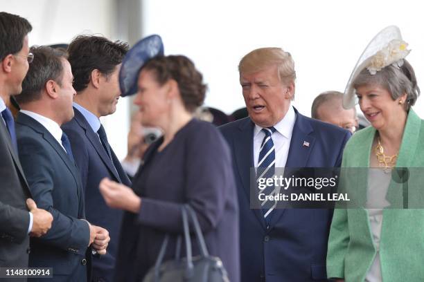 President Donald Trump and Britain's Prime Minister Theresa May arrive to attend an event to commemorate the 75th anniversary of the D-Day landings,...