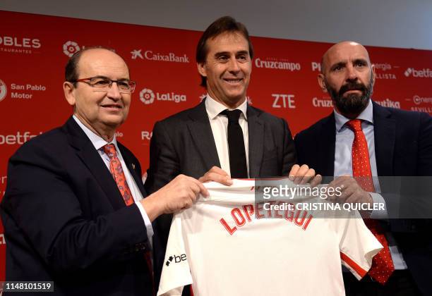 Julen Lopetegui poses with the president of Sevilla FC, Jose Castro and the team's director of football, Monchi, during Lopetegui's presentation as...