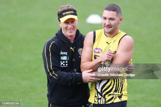 Tigers head coach Damien Hardwick hugs Shaun Grigg of the Tigers during a Richmond Tigers AFL training session at Punt Road Oval on May 10, 2019 in...