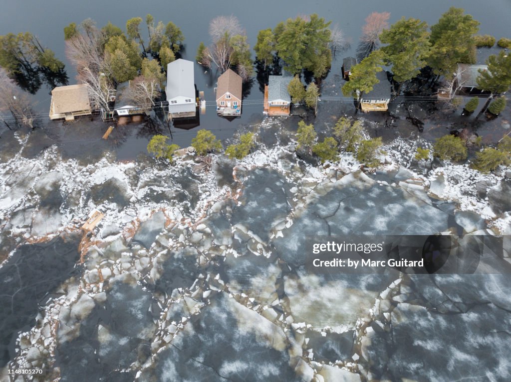 Huge chunks of ice propelled by wind and flood waters threaten cottages on Grand Lake, New Brunswick, Canada
