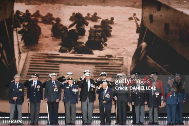 Day veterans are presented on stage during an event to commemorate the 75th anniversary of the D-Day landings, in Portsmouth, southern England, on...