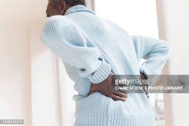 woman with back pain - older woman bending over stock pictures, royalty-free photos & images