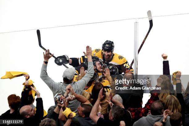 Zdeno Chara celebrates with Chris Wagner of the Boston Bruins after Wagner scored a third period goal against the Carolina Hurricanes in Game One of...