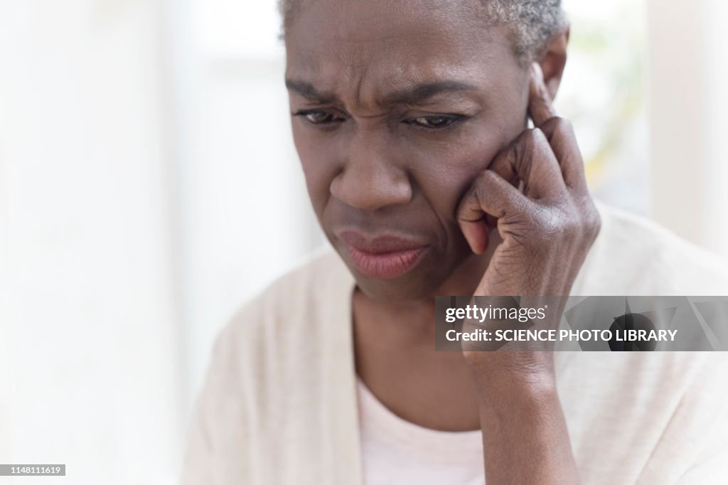 Woman touching ear