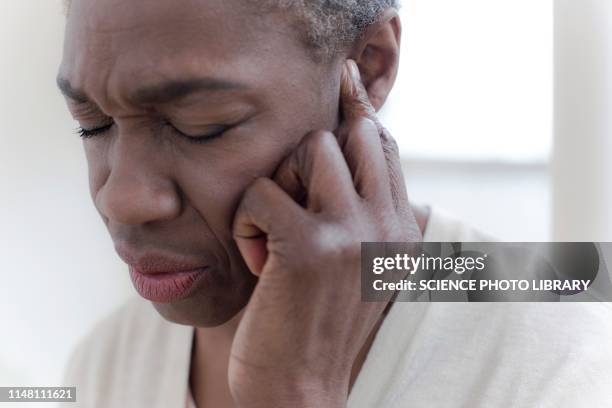 woman touching ear - woman fingers in ears stock pictures, royalty-free photos & images